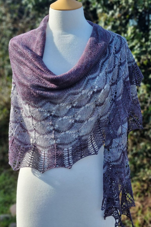 Knitted shawl on a mannequin with a natural background